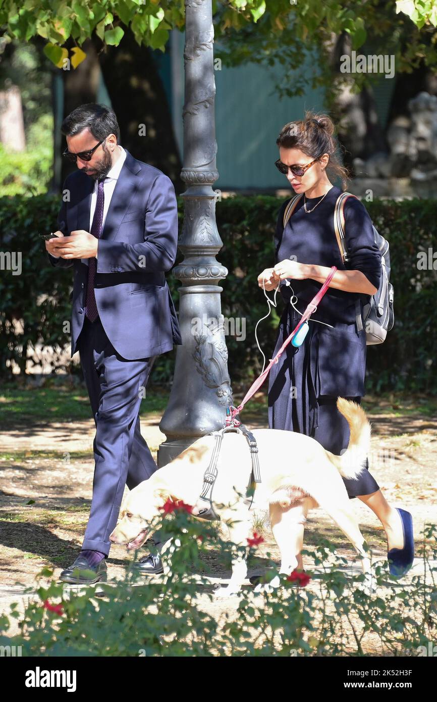 Catrinel Marlon (R) and companion Massimiliano Di Lodovico (L) walk