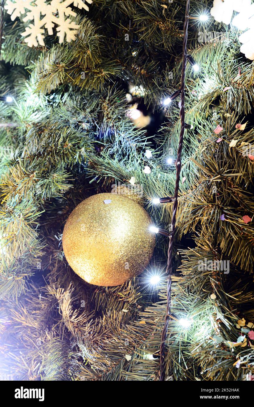 Christmas background with Christmas tree decorations. Detail with lights, balls and other decorations of a Christmas tree. Stock Photo