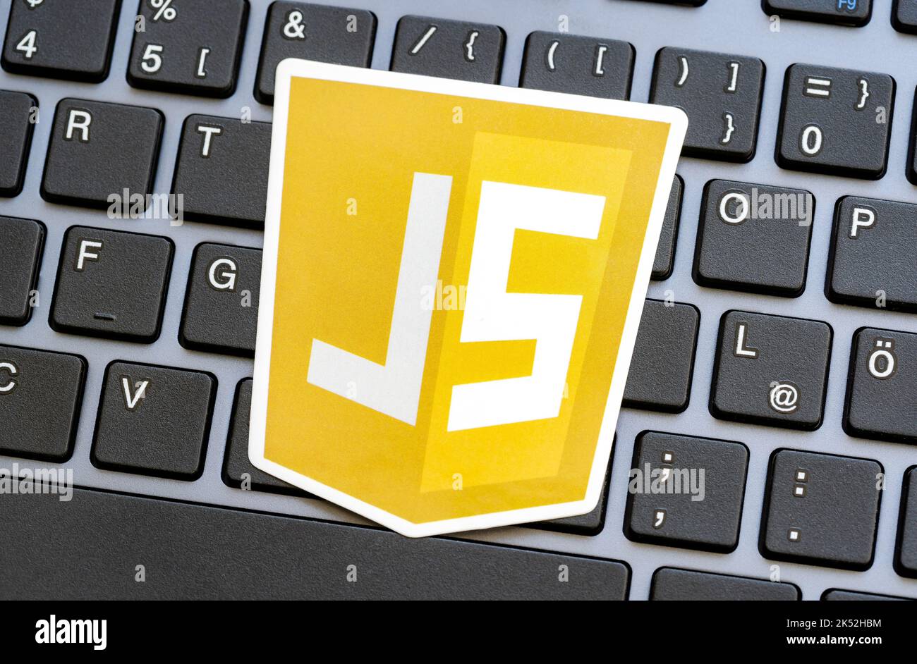 JS, JavaScript programming language logo laying on a modern computer keyboard, nobody. Web development, browser scripts, web page scripting security c Stock Photo