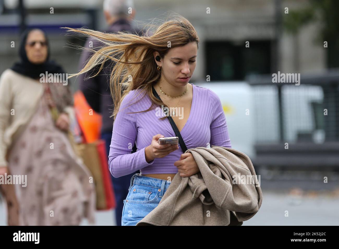 A woman seen using her mobile phone while walking outside Warren Street ...