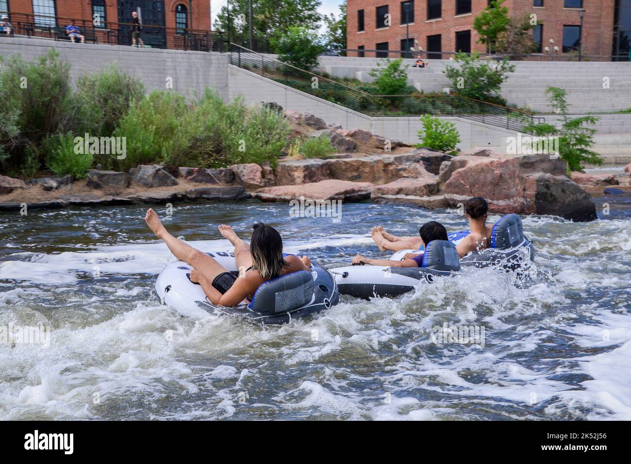 Friends have fun floating down the South Platte River in Denver on