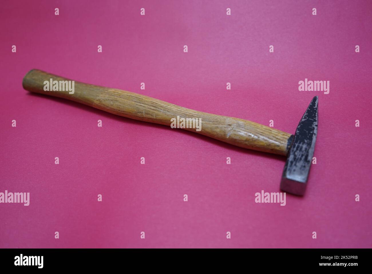 old vintage hammer isolated on red background Stock Photo