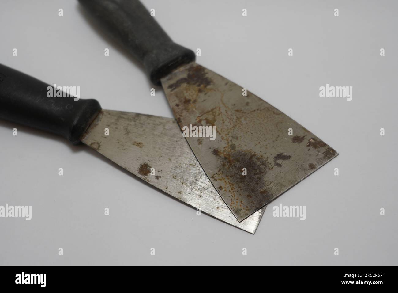 Putty knives with wooden handles, Closeup a new metallic putty knife