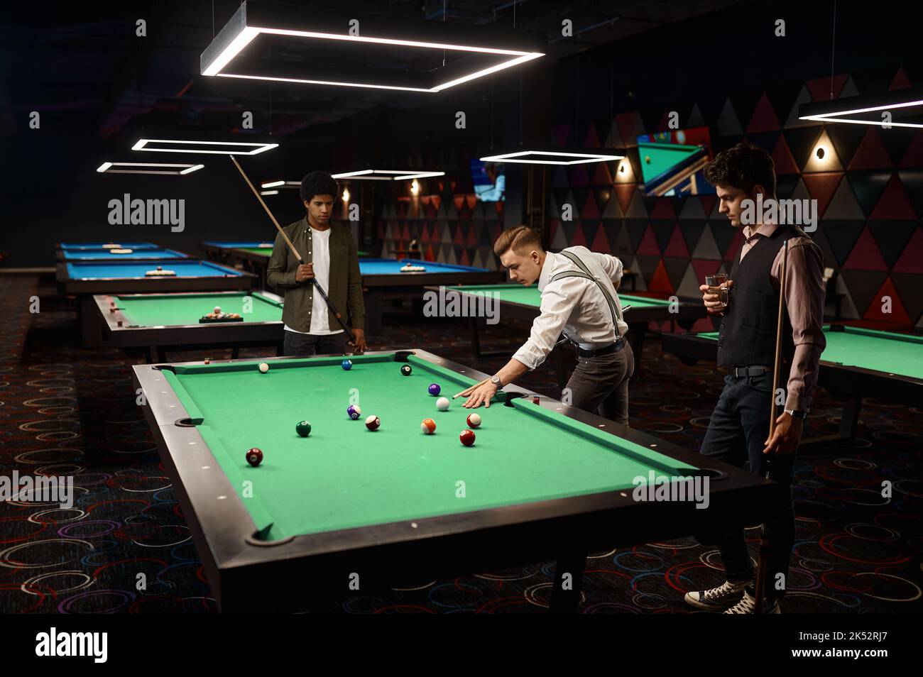 Friends enjoying billiard game at pool hall Stock Photo Alamy