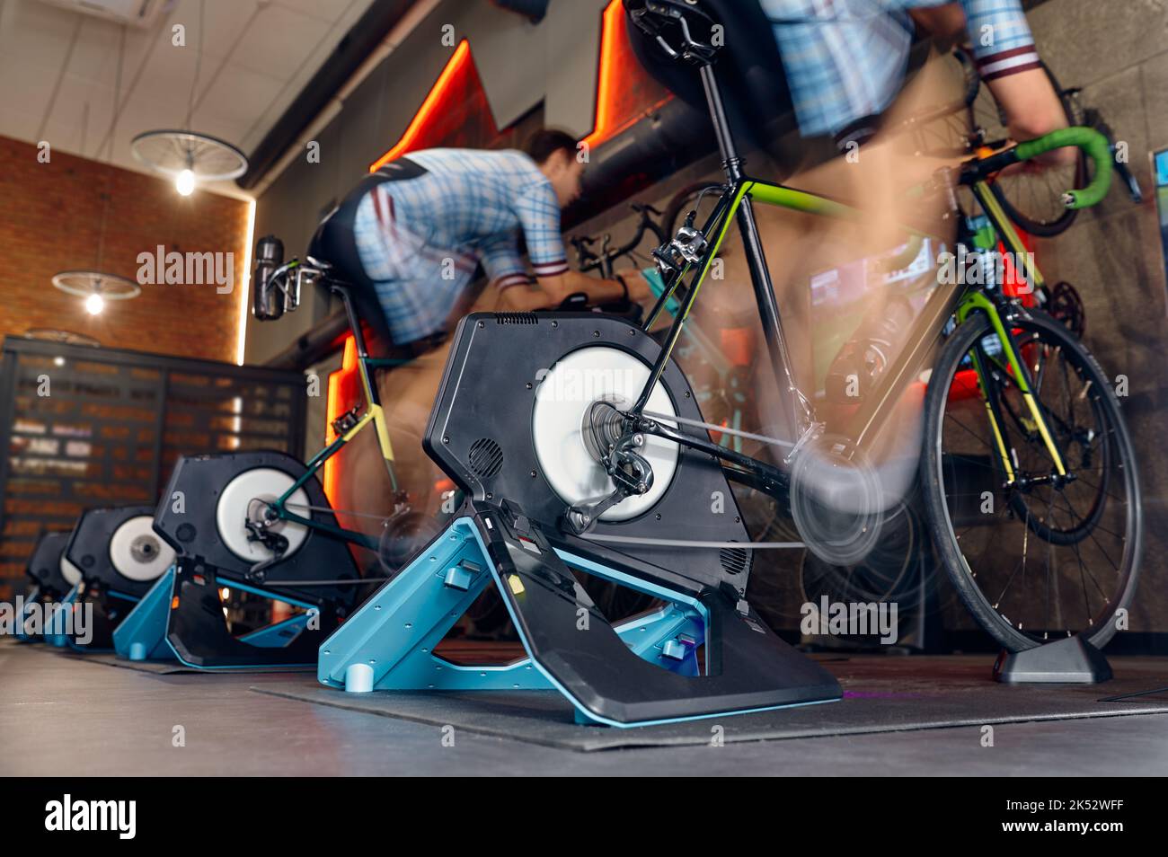 Man cycling gym machine equipment, motion blur Stock Photo