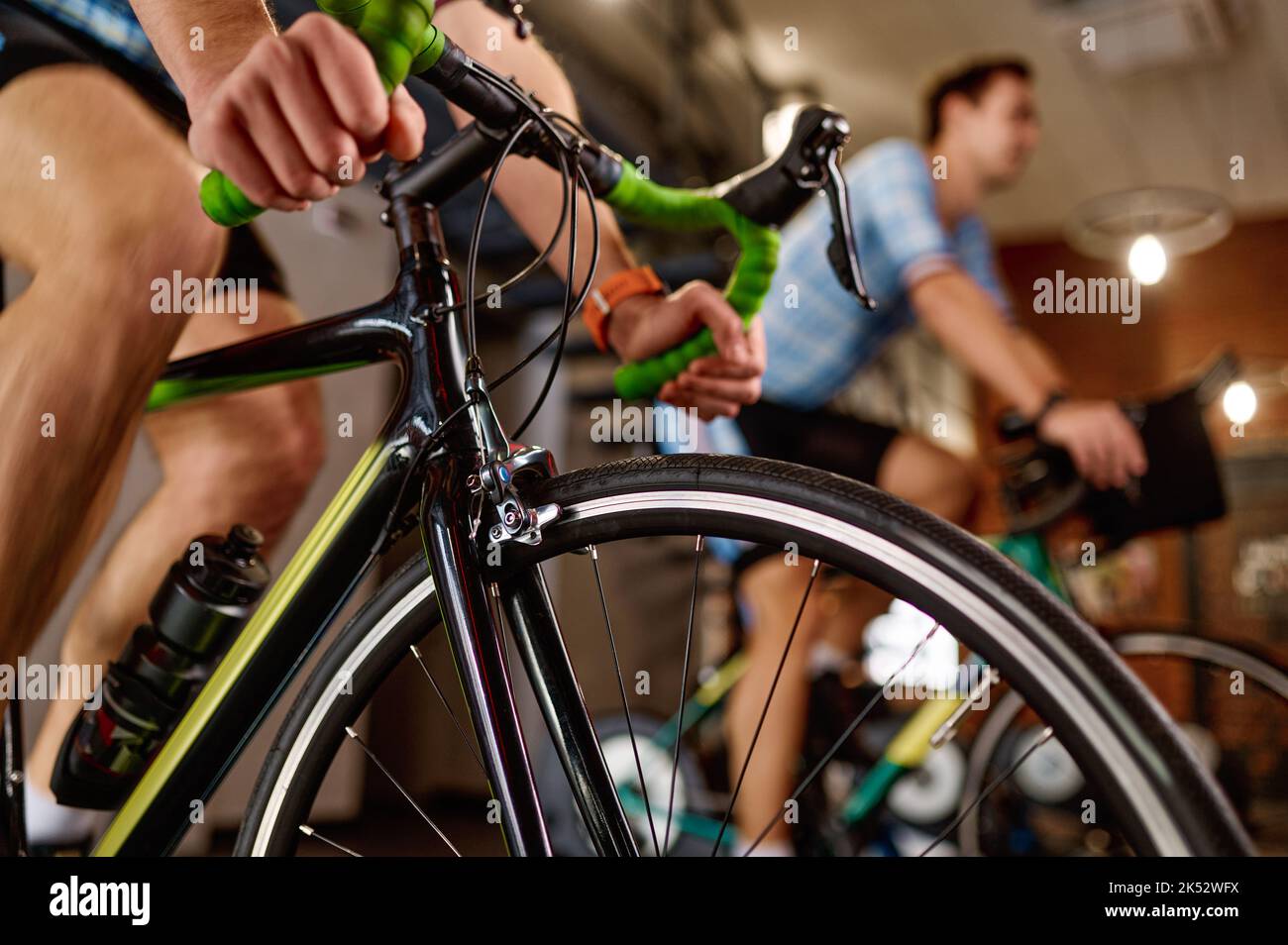Closeup cycling training on bike at gym club Stock Photo