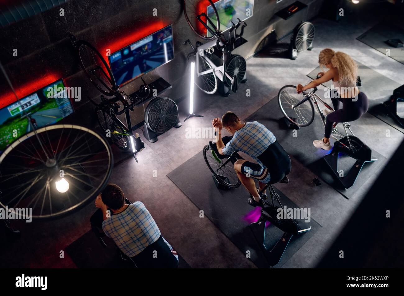 Group of sports people riding stationary bike at gym Stock Photo Alamy