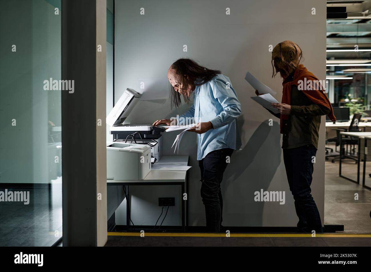 Zombie manager group in queue for copier at office Stock Photo