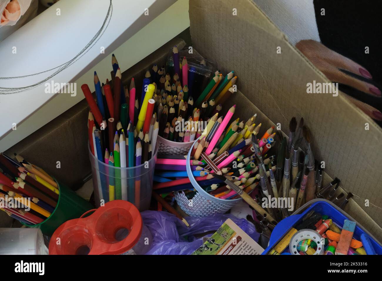 Colored pencils in a pencil case on box background Stock Photo