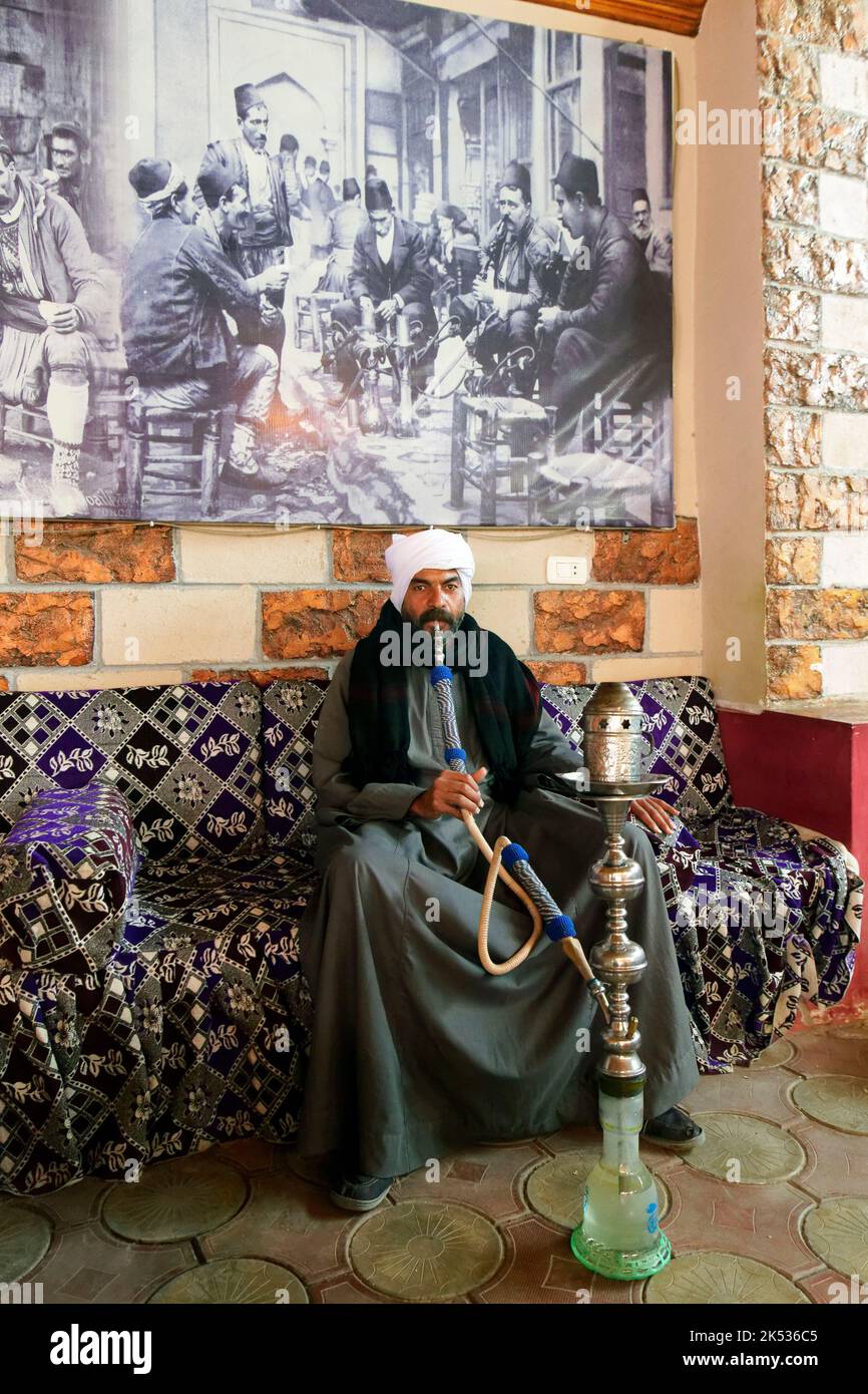 Egypt, Middle Egypt, Nile Valley, Abydos, man smoking shisha or narghile pipe Stock Photo