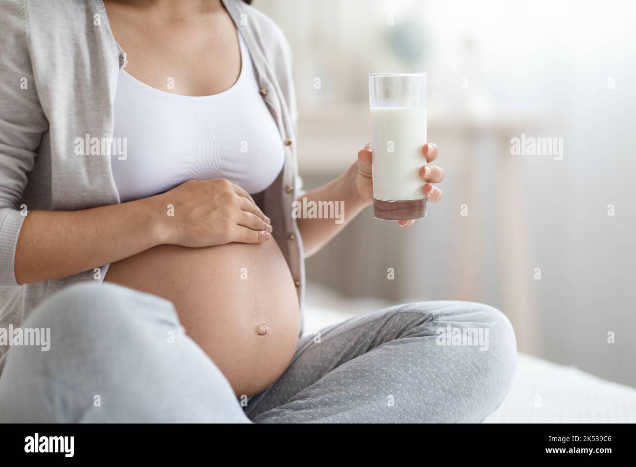 Unrecognizable pregnant woman holding glass of milk Stock Photo