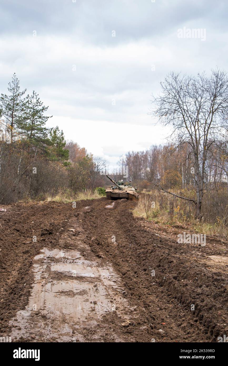 Russian tank rides on a forest road Stock Photo