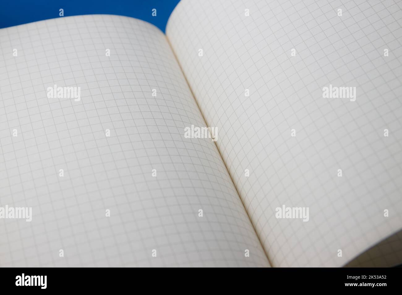 Close-up of a white page notebook with squares opened by a random pages Stock Photo