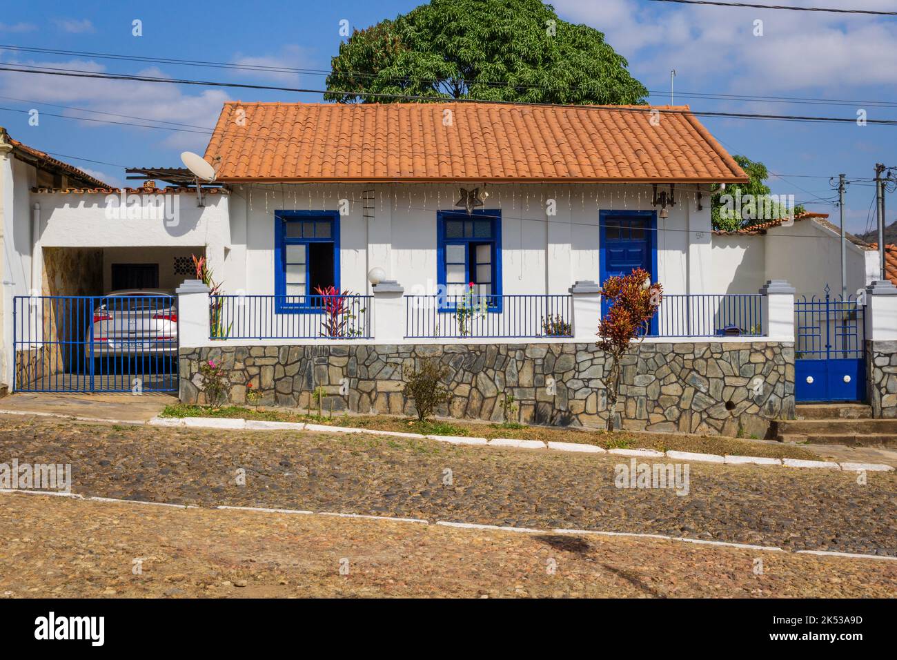 Colonial white house with cobalt blue doors and windows in Sabará, Minas Gerais, Brazil. Stock Photo