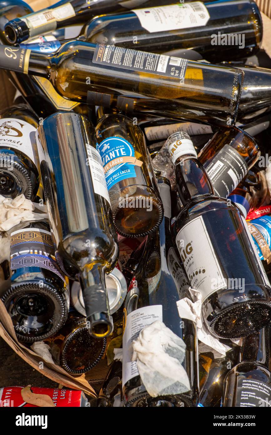 selection of glass bottles in a recycling bin ready for collection, coloured glass bottles ready
