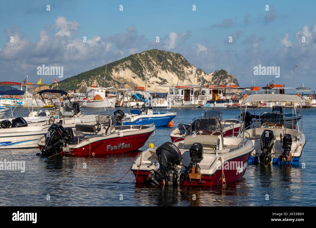 marathonisi island on the coast of zante or zakynthos in greece, boats moored in keri harbour on zakynthos with marathinisi in the background. Stock Photo