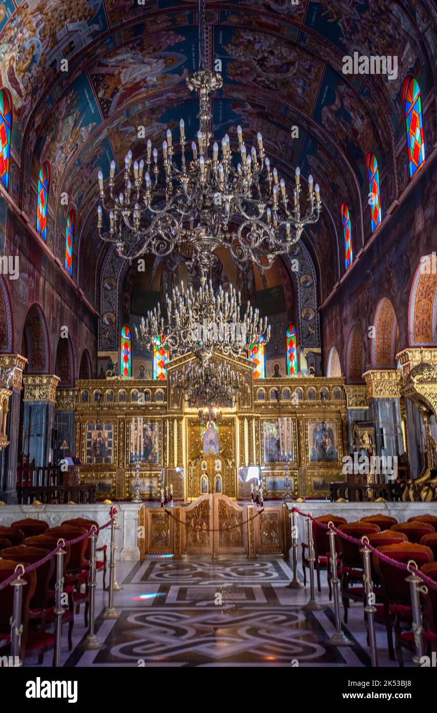 interior of saint dionysios church on the greek island of zante or zakynthos in greece with chandeliers and wall paintings of religious orthodox items Stock Photo