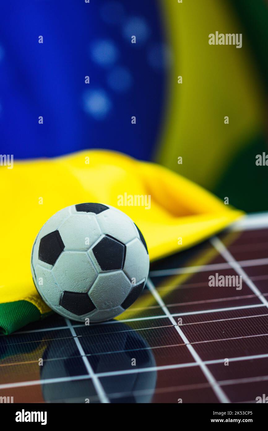 Soccer Ball and Brazil Flag over Photovoltaic Solar Panel. World Cup