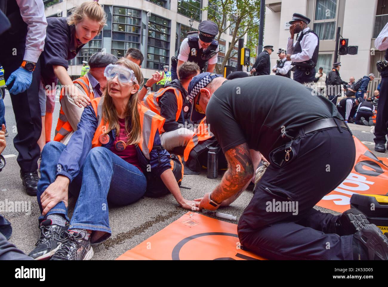London, UK. 05th Oct, 2022. Police officers use solvent to dissolve the