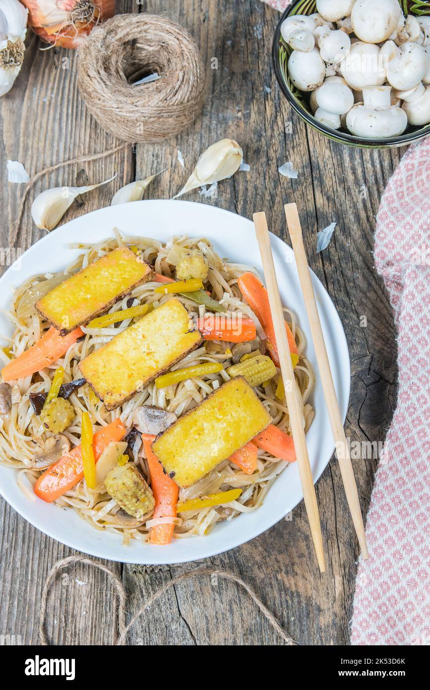 Rice noodles with roasted vegetables and tofu slices. Asian traditional food. Asian rice pasta