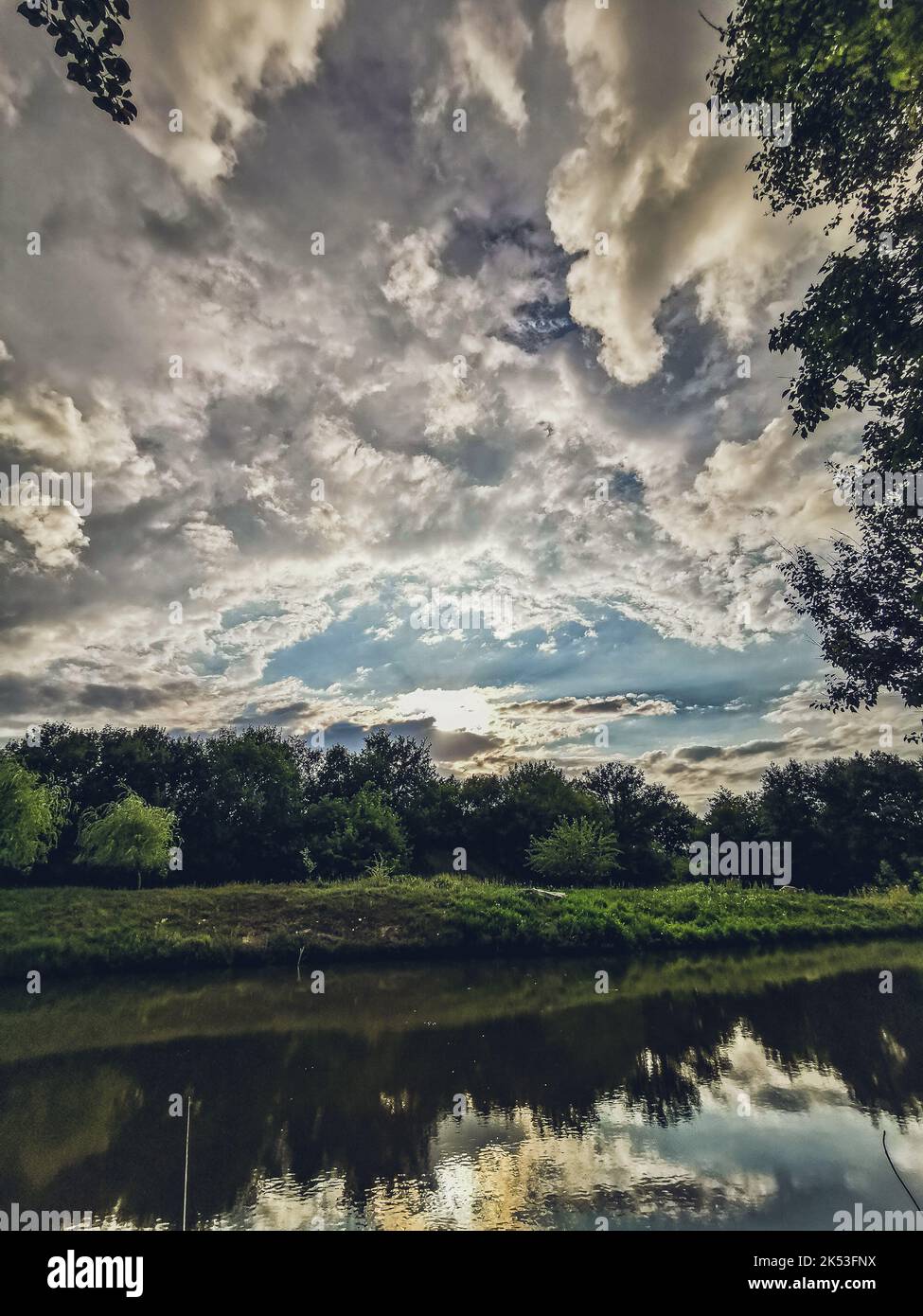 A breathtaking view of white cloudscape in the blue sky over the lake ...