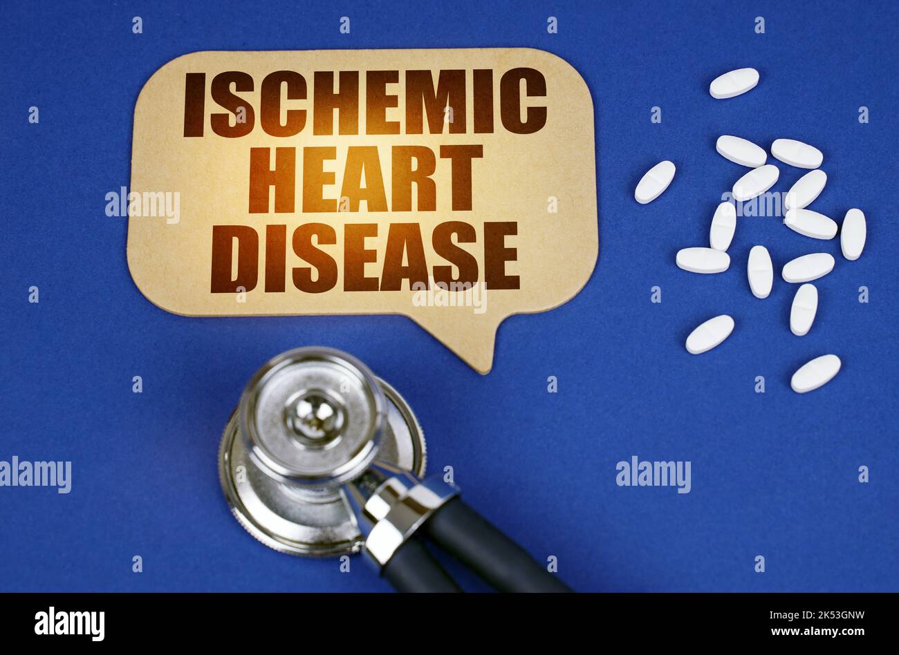 Medical concept. On the blue surface of the tablet, a stethoscope and a cardboard sign with the inscription - Ischemic Heart Disease Stock Photo
