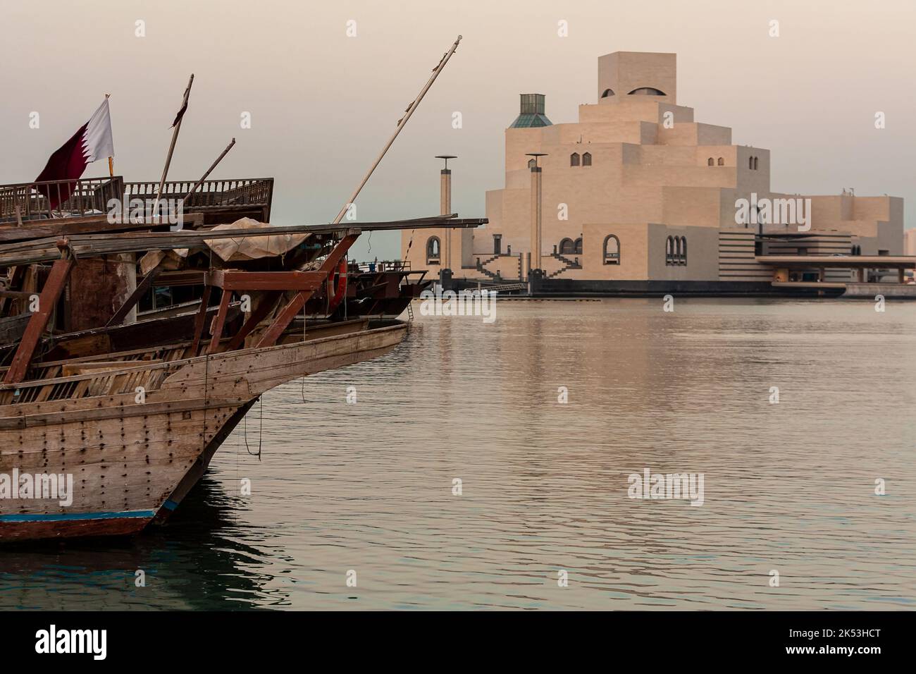 DOHA, QATAR - NOVEMBER 24 2008: The Museum of Islamic Art and traditional dhow boats, with Qatari flags in Doha, Qatar Stock Photo