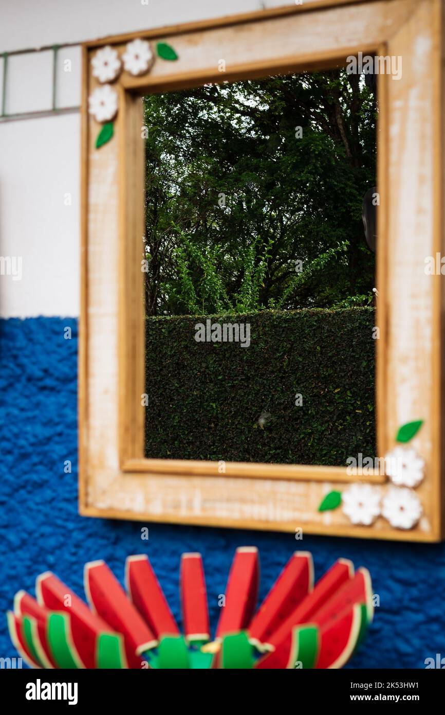 Mirror for sale reflecting the greenery in São Sebastião das Águas Claras, Macacos, Minas Gerais, Brazil. Stock Photo