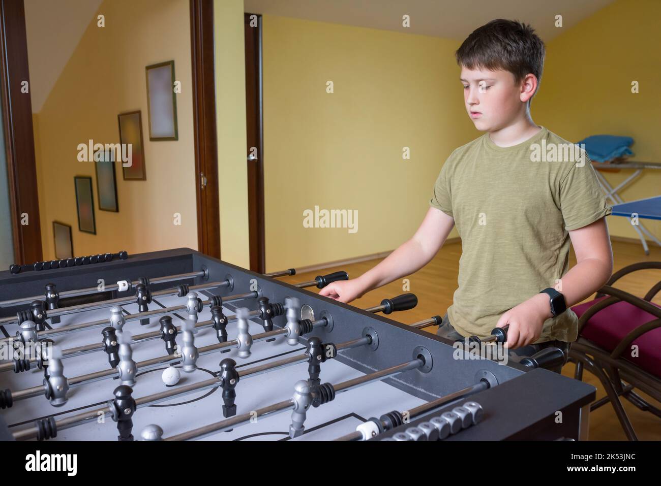 A boy plays table football. Sports concept Stock Photo