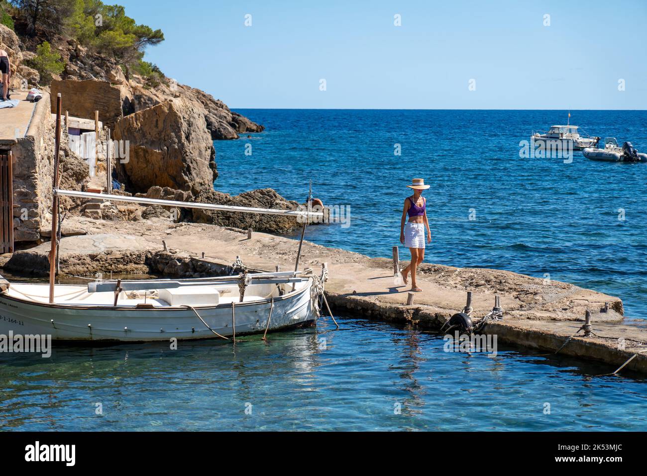 Woman walking on a pier in the mediterranean sea Stock Photo