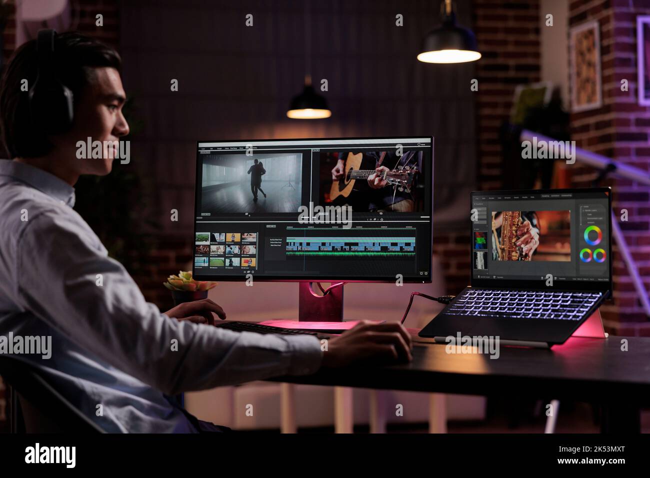 Asian editor working on movie production with computer software ...