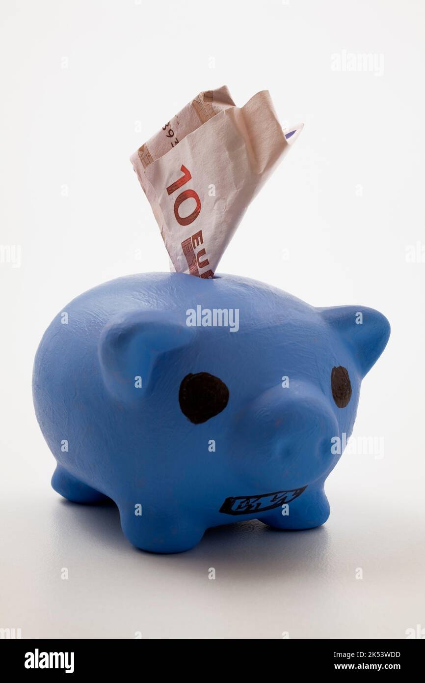 Blue ceramic piggy bank with Euro currency bank note Stock Photo - Alamy