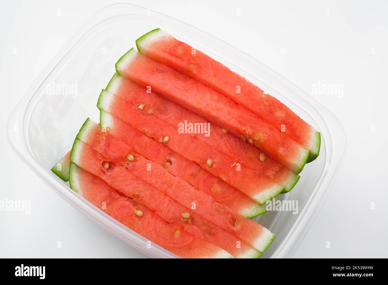 Citrullus lanatus - Watermelon slices in plastic container. Stock Photo