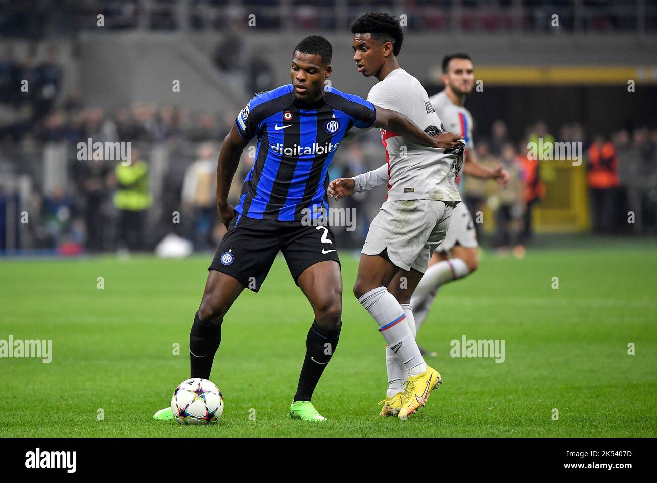 Denzel Dumfries of Fc Internazionale and Alejandro Balde of Barcelona compete for the ball during the Champions League Group C football match between Stock Photo