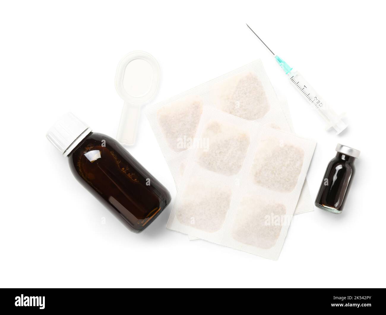 Mustard plasters, ampule, syringe and cough syrup on white background