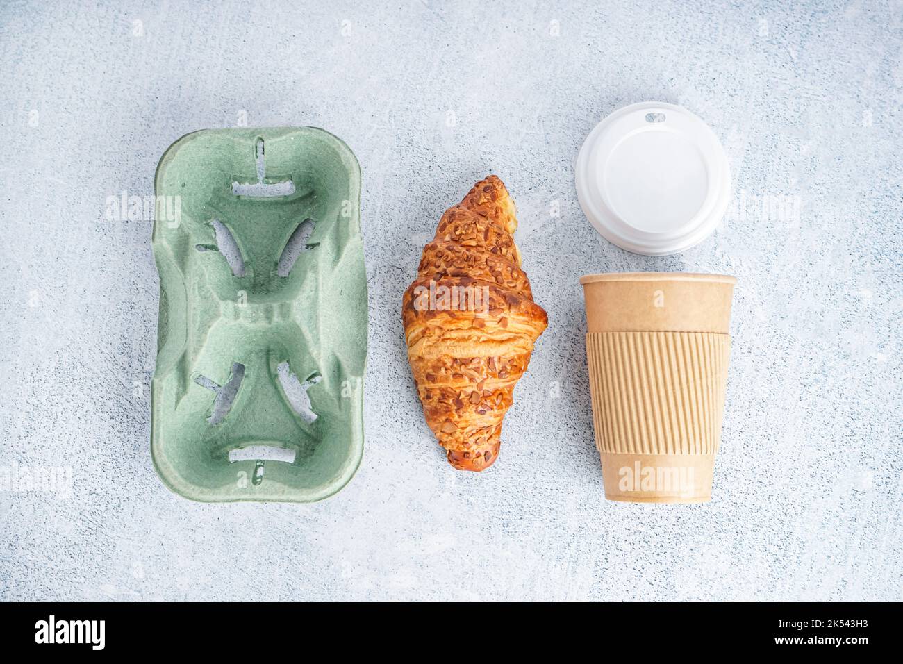 Paper cup, cap, holder and tasty croissant on light background Stock ...