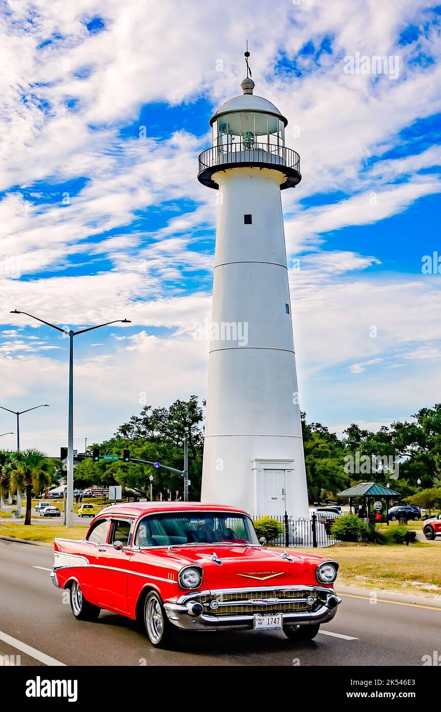 A 1957 Chevrolet Bel Air passes the Biloxi lighthouse during the 26th annual Cruisin’ the Coast antique car festival in Biloxi, Mississippi. Stock Photo