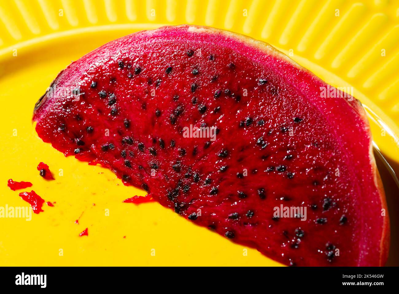 pink pitaya on a yellow plate Stock Photo