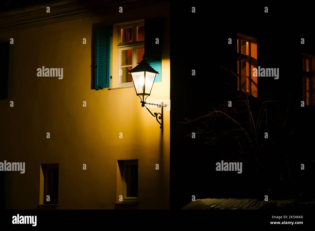 Lighting in winter. Lantern in the dark.Light in the dark. Warm lamplight. Stock Photo