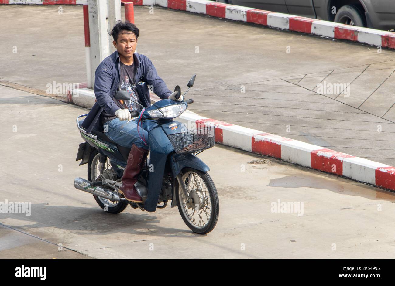 SAMUT PRAKAN, THAILAND, SEP 23 2022, A man  rides a motorcycle at the street Stock Photo