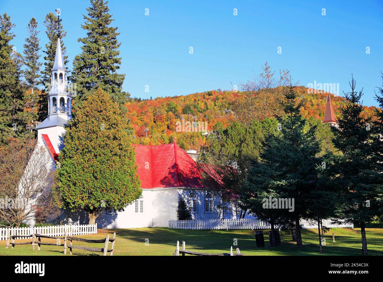 Church surrounded by colorful autumn leaves at Mont Tremblant Stock Photo