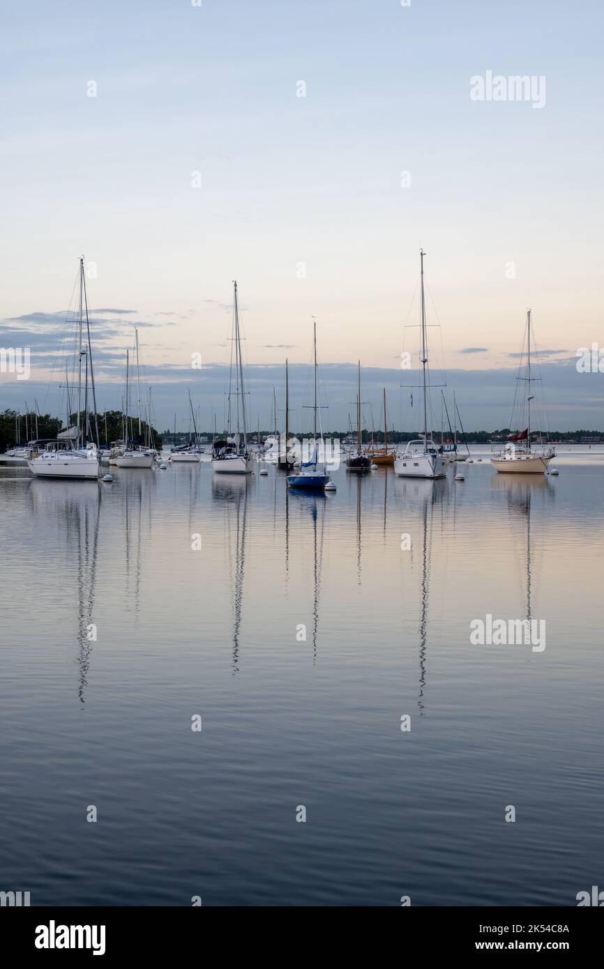 Sailboats in Dinner Key anchorage reflected in calm water of Biscayne ...