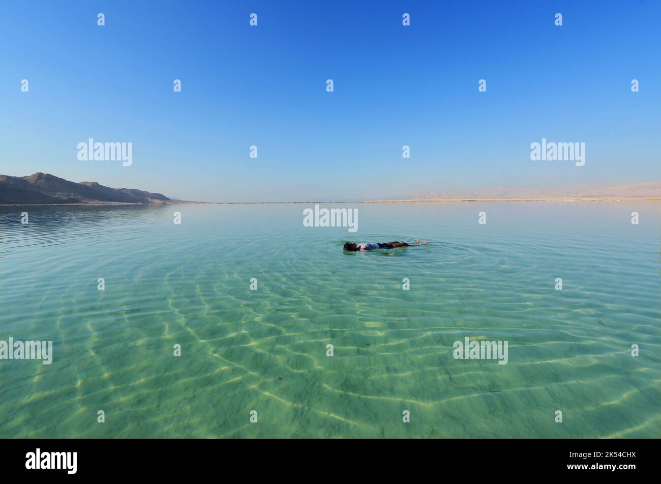 Floating on the salty water of the Dead Sea in Israel. Stock Photo