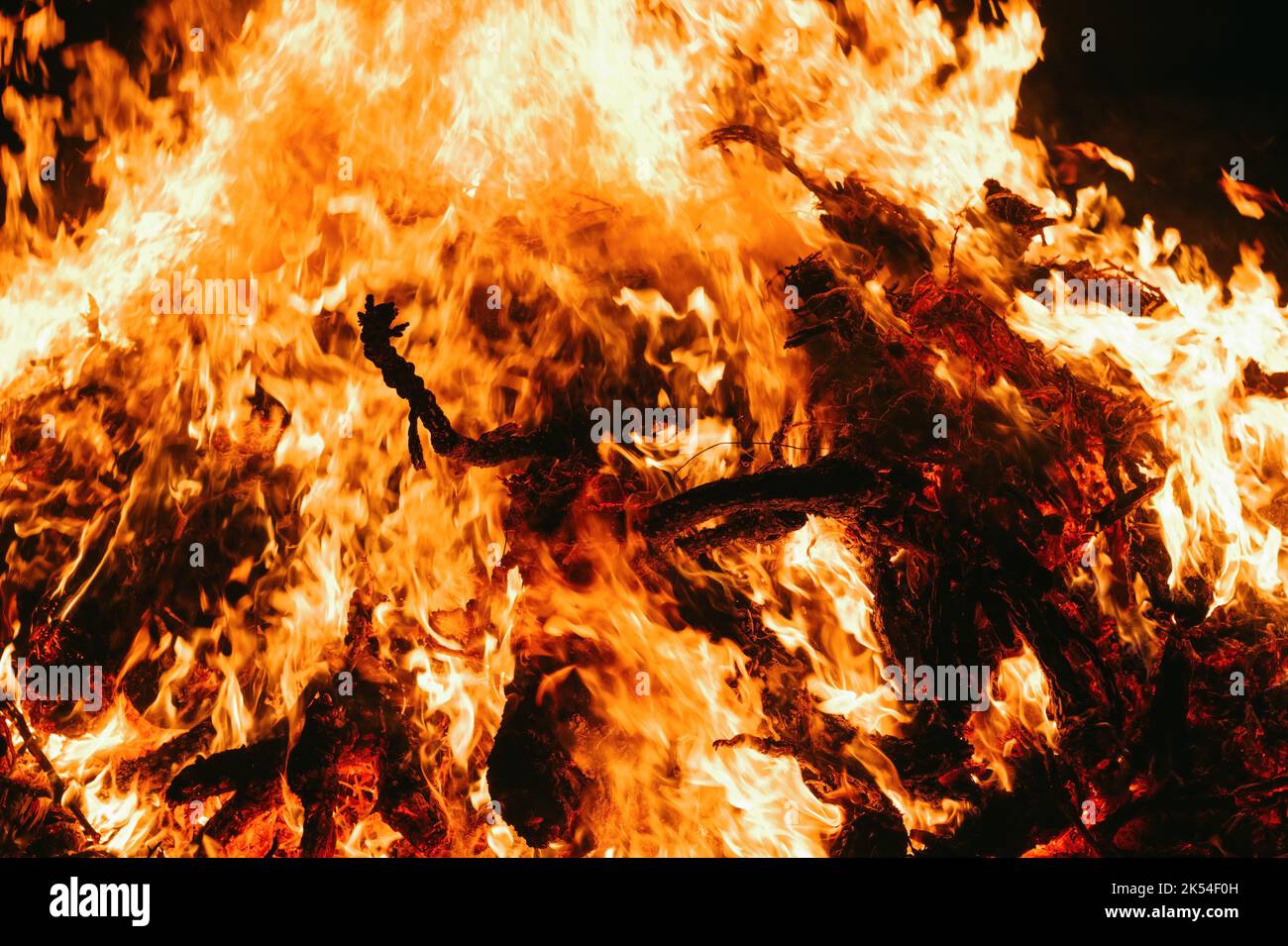 A Fire embers particles over black background. Fire sparks background. Abstract dark glitter fire particles lights. bonfire in motion blur. Stock Photo