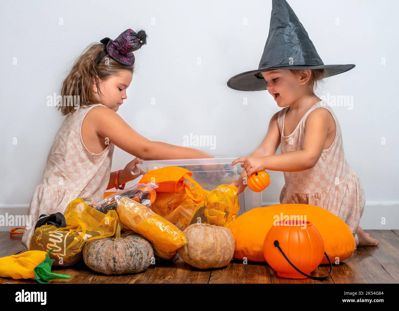 Children take apart a container of Halloween decorations Stock Photo