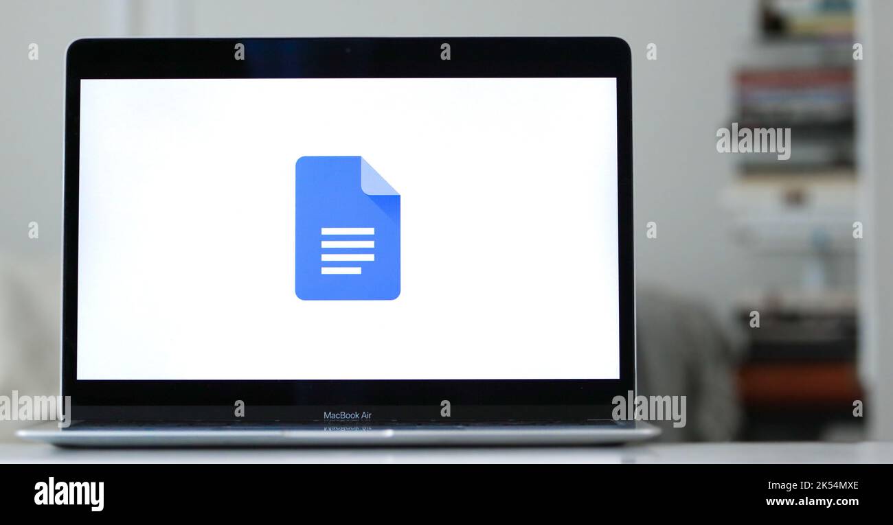 A logo design of google docs on a laptop screen in blurred background Stock Photo
