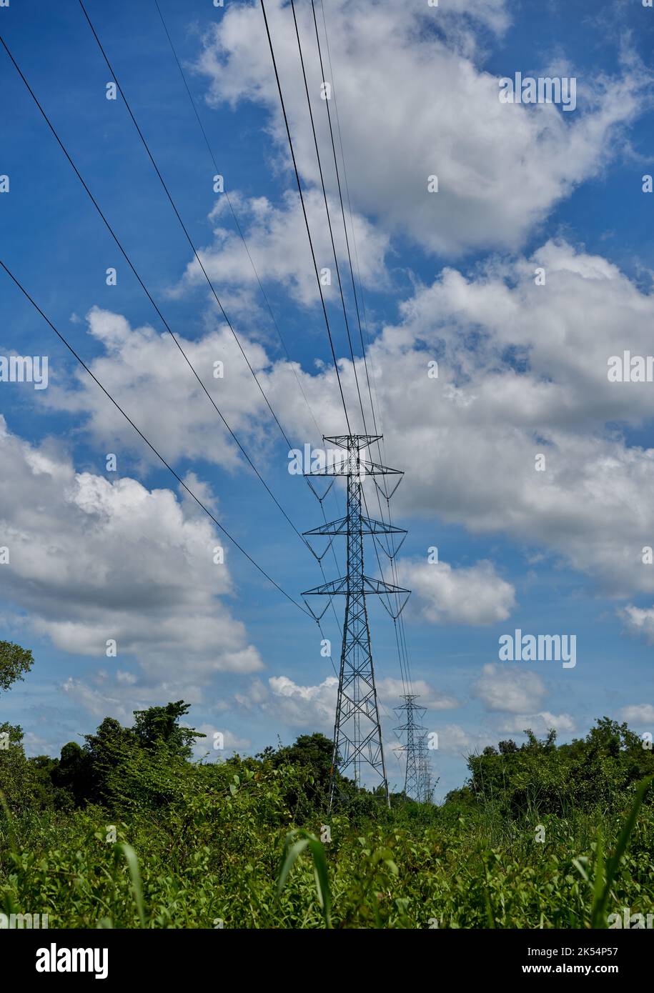 Electricity pylons with blue sky and white clouds Stock Photo - Alamy