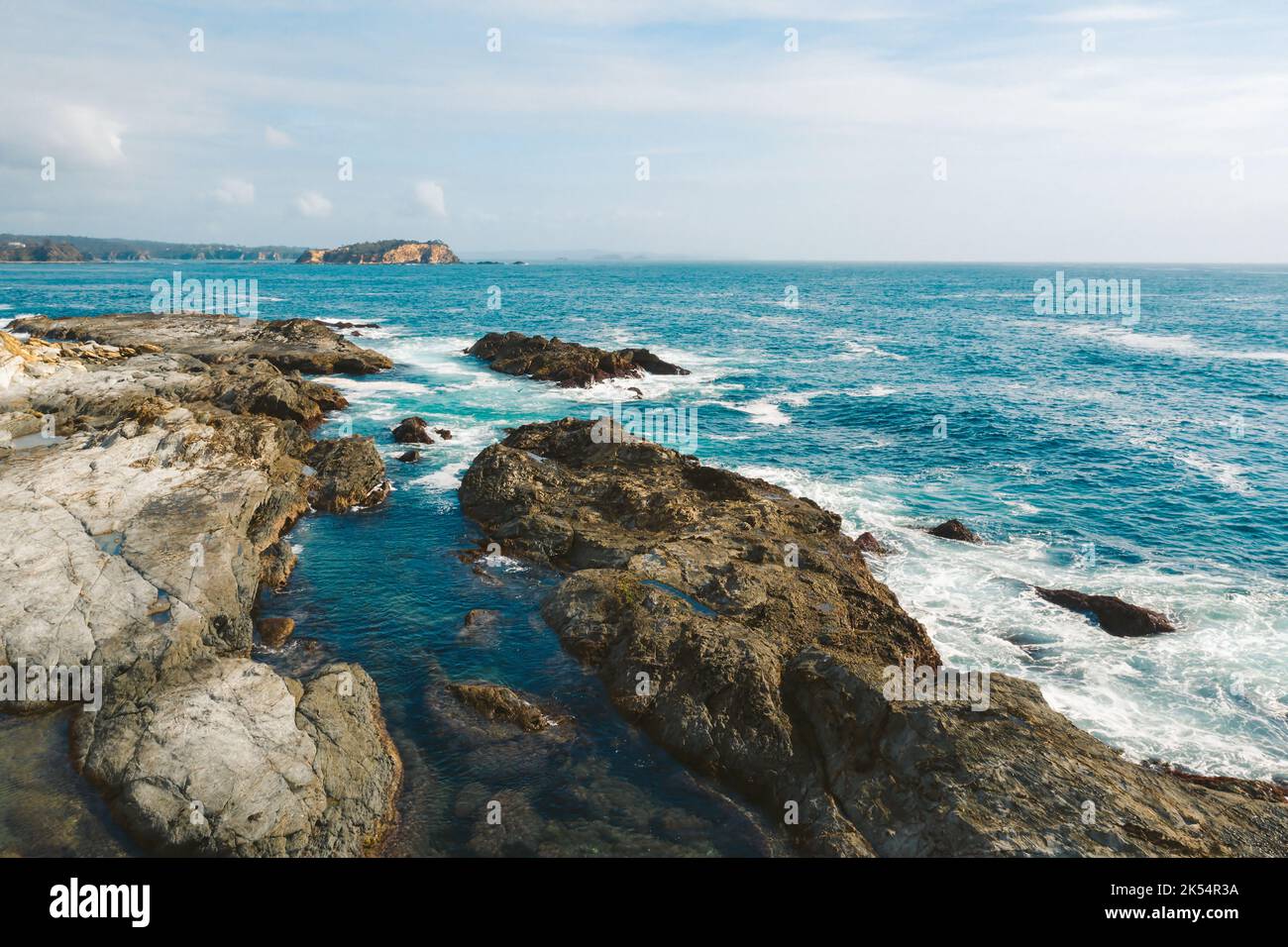 Coastal seascape with rocky fingers protruding the coast and views to the small islands Stock Photo