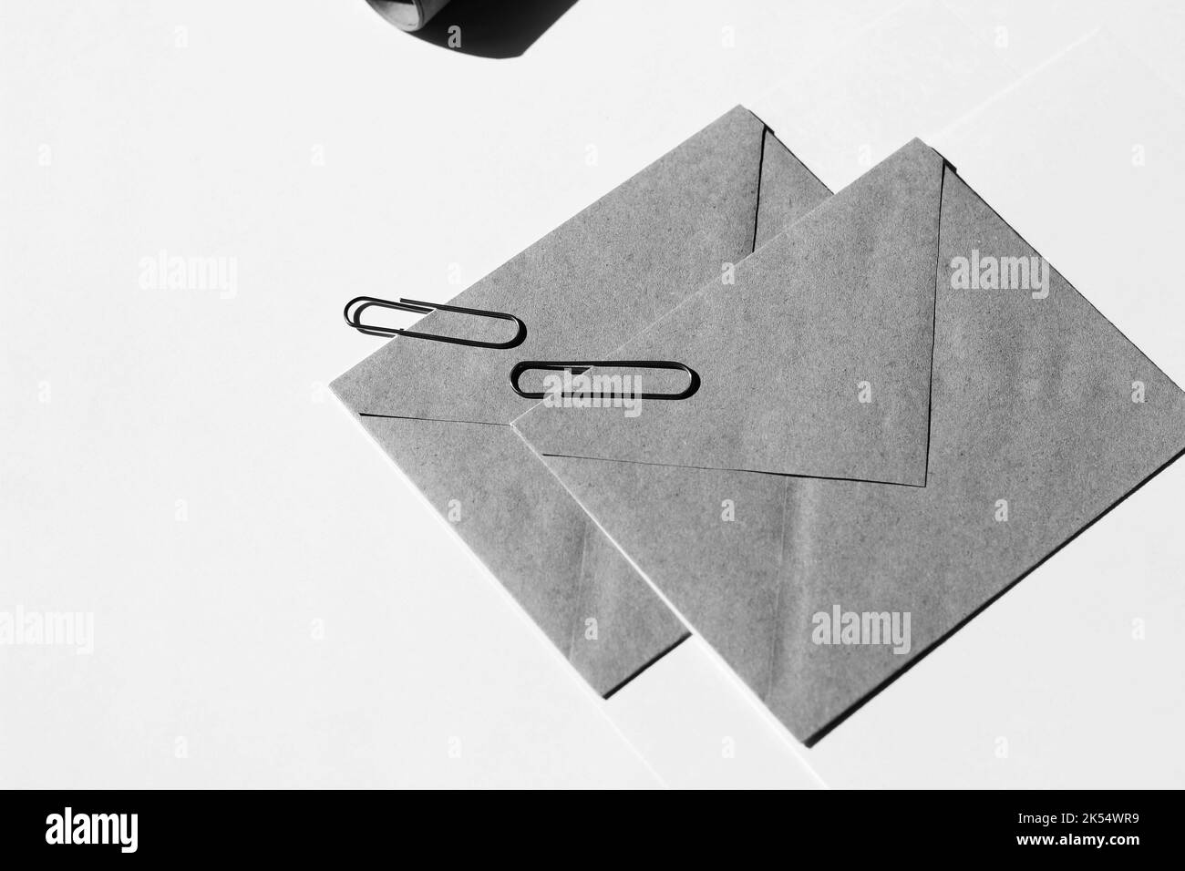 Office Desk with Kraft Paper Envelopes, Paper Clips. Stationery. Minimal Branding Concept. Stock Photo
