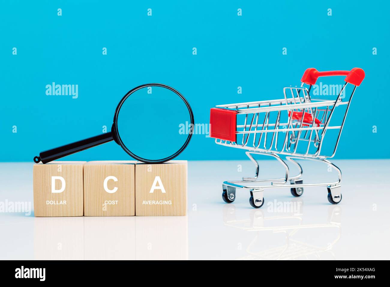 magnifying-glass-and-dca-word-on-a-wooden-cube-in-idea-dollar-cost